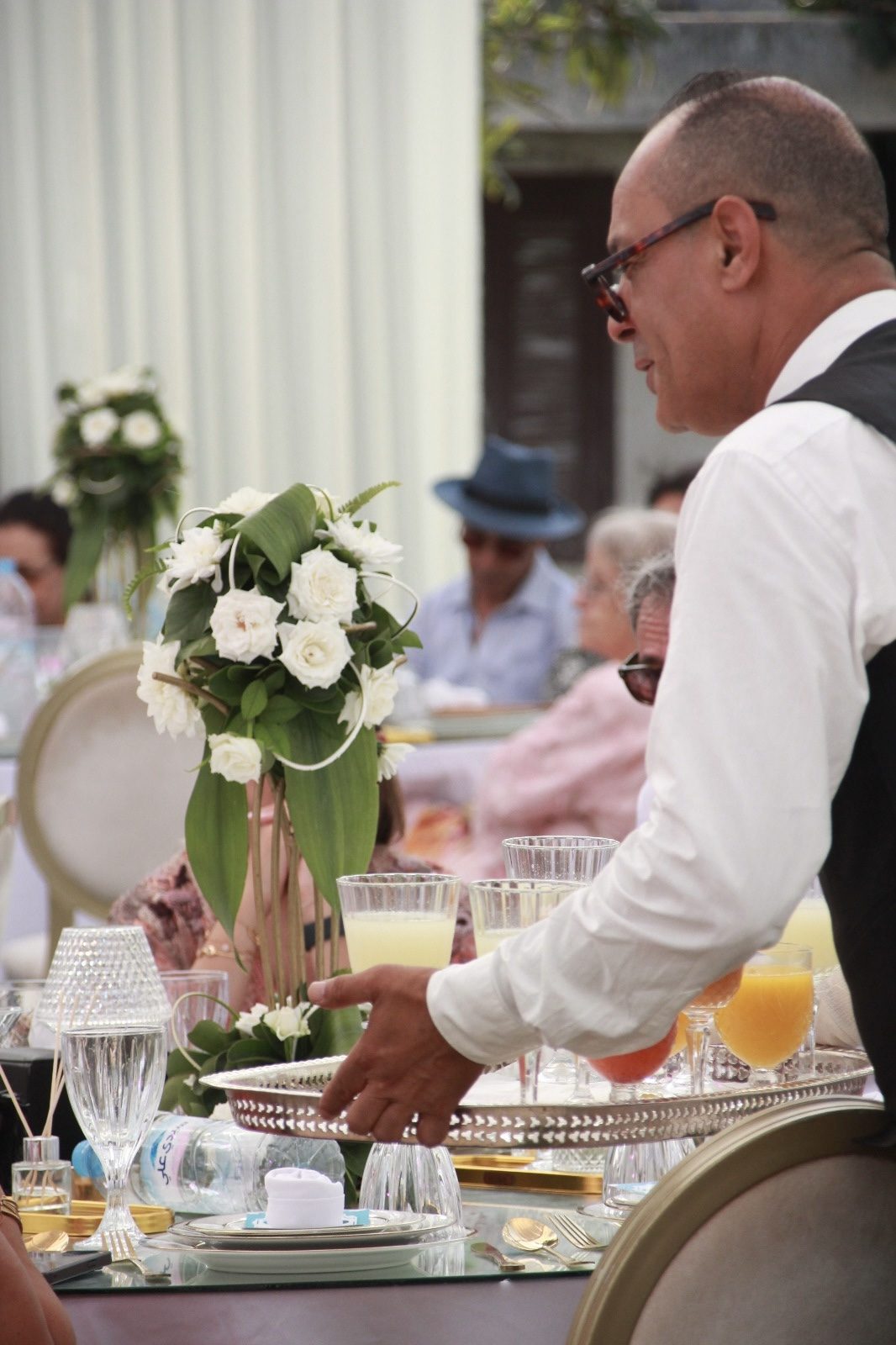 Serveur présentant un plateau de jus de bienvenue aux invités